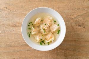shrimp dumpling soup in white bowl photo