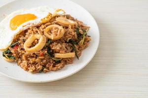 fried rice with squid and basil topped fried egg in Thai style photo