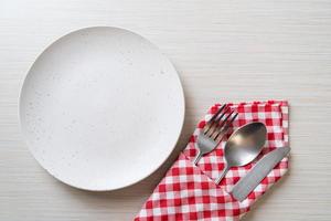 empty plate or dish with knife, fork and spoon photo