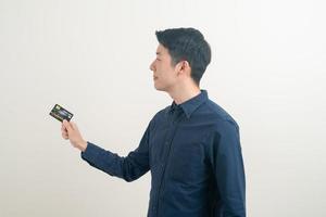 young Asian man holding credit card photo