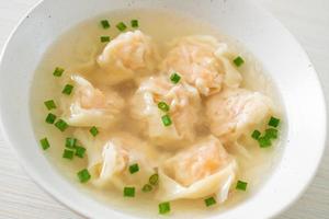 shrimp dumpling soup in white bowl photo