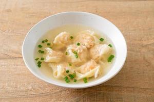 shrimp dumpling soup in white bowl photo