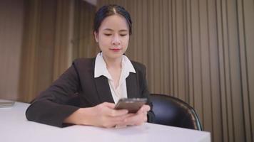 Successful business woman using smart phone application, city lifestyle and technology. professional female receiving good news excited happy cheerful, relaxing using phone, online social media app