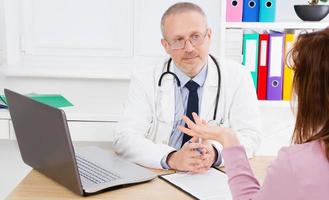 doctor carefully listens to the patient's complaints in medical office photo