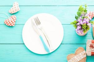 Romantic dinner,flowers and hearts on wooden background. Mock up and copy space photo