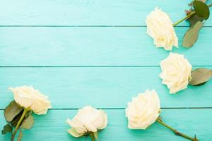 Summer White roses on blue wooden background with copy space. Top view. Mock up. Mother Valentine day. Wedding concept photo