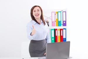Smiling Businesswoman and big thumb up isolated on white background at office. Business success concept. Woman at work photo