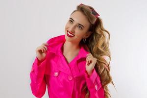 Happy, shock, excited woman face closeup. Girl bright pink autumn clothes, makeup isolated, white background, copy space. Beautiful female surprised, cheerful. Fun funny model smiling, Close-up face photo