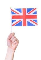 Hand holding flag of UK, isolated on white background photo