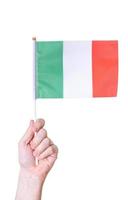 A hand holds the flag The flag of Italy on a white isolated background. photo