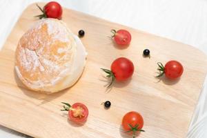 Fresh maritozzo with hokkido cream on wooden background. photo