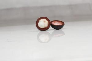 Mangosteen is a tropical fruit from Asia. Mangosteen has a distinctive sweet and sour taste. Mangosteen also has a myriad of benefits, properties, and nutritional content that is useful for health. photo