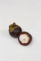 Mangosteen is a tropical fruit from Asia. Mangosteen has a distinctive sweet and sour taste. Mangosteen also has a myriad of benefits, properties, and nutritional content that is useful for health. photo