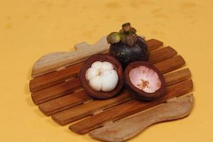 Mangosteen is a tropical fruit from Asia. Mangosteen has a distinctive sweet and sour taste. Mangosteen also has a myriad of benefits, properties, and nutritional content that is useful for health. photo