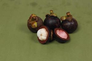 Mangosteen is a tropical fruit from Asia. Mangosteen has a distinctive sweet and sour taste. Mangosteen also has a myriad of benefits, properties, and nutritional content that is useful for health. photo