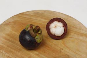 Mangosteen is a tropical fruit from Asia. Mangosteen has a distinctive sweet and sour taste. Mangosteen also has a myriad of benefits, properties, and nutritional content that is useful for health. photo
