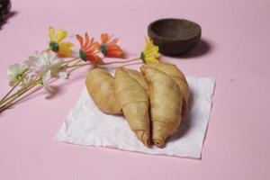 Chocolate bananas from raw materials covered with rolls of pastry dough sheets. Molen bananas with pastries are usually served with a cup of hot coffee or tea. Focus blur photo