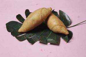 Chocolate bananas from raw materials covered with rolls of pastry dough sheets. Molen bananas with pastries are usually served with a cup of hot coffee or tea. Focus blur photo