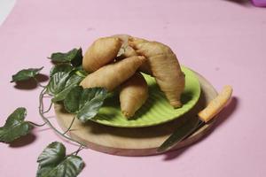 Chocolate bananas from raw materials covered with rolls of pastry dough sheets. Molen bananas with pastries are usually served with a cup of hot coffee or tea. Focus blur photo