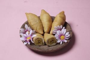 Chocolate bananas from raw materials covered with rolls of pastry dough sheets. Molen bananas with pastries are usually served with a cup of hot coffee or tea. Focus blur photo