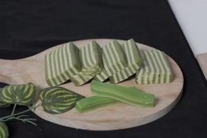 Original and pandan flavored layer cake. Layer cake is ready to accompany your morning with a glass of tea. Indonesian cake. We often see it as a side dish during Eid. Sweet and soft cake. Focus blur. photo