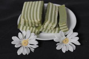 Original and pandan flavored layer cake. Layer cake is ready to accompany your morning with a glass of tea. Indonesian cake. We often see it as a side dish during Eid. Sweet and soft cake. Focus blur. photo