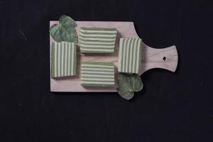 Original and pandan flavored layer cake. Layer cake is ready to accompany your morning with a glass of tea. Indonesian cake. We often see it as a side dish during Eid. Sweet and soft cake. Focus blur. photo