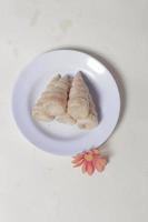 In Indonesia, this cake is known as cumcum cake. A cake shaped like a trumpet, or an ice cream cone. The perfect combination of a dry cake studded with sugar, plus a delicious cream vanilla filling. photo