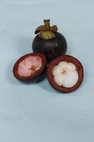 Mangosteen is a tropical fruit from Asia. Mangosteen has a distinctive sweet and sour taste. Mangosteen also has a myriad of benefits, properties, and nutritional content that is useful for health. photo