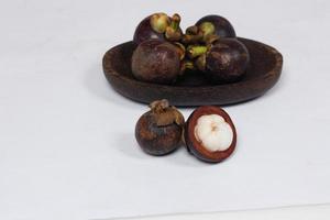 Mangosteen is a tropical fruit from Asia. Mangosteen has a distinctive sweet and sour taste. Mangosteen also has a myriad of benefits, properties, and nutritional content that is useful for health. photo