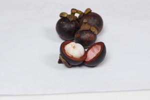 Mangosteen is a tropical fruit from Asia. Mangosteen has a distinctive sweet and sour taste. Mangosteen also has a myriad of benefits, properties, and nutritional content that is useful for health. photo