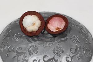 Mangosteen is a tropical fruit from Asia. Mangosteen has a distinctive sweet and sour taste. Mangosteen also has a myriad of benefits, properties, and nutritional content that is useful for health. photo