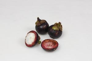 Mangosteen is a tropical fruit from Asia. Mangosteen has a distinctive sweet and sour taste. Mangosteen also has a myriad of benefits, properties, and nutritional content that is useful for health. photo