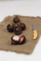 Mangosteen is a tropical fruit from Asia. Mangosteen has a distinctive sweet and sour taste. Mangosteen also has a myriad of benefits, properties, and nutritional content that is useful for health. photo