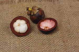 Mangosteen is a tropical fruit from Asia. Mangosteen has a distinctive sweet and sour taste. Mangosteen also has a myriad of benefits, properties, and nutritional content that is useful for health. photo