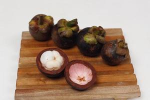 Mangosteen is a tropical fruit from Asia. Mangosteen has a distinctive sweet and sour taste. Mangosteen also has a myriad of benefits, properties, and nutritional content that is useful for health. photo