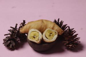 Chocolate bananas from raw materials covered with rolls of pastry dough sheets. Molen bananas with pastries are usually served with a cup of hot coffee or tea. Focus blur photo