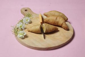 Chocolate bananas from raw materials covered with rolls of pastry dough sheets. Molen bananas with pastries are usually served with a cup of hot coffee or tea. Focus blur photo