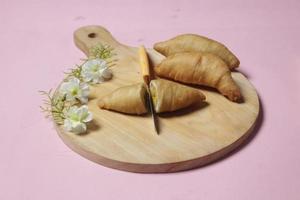 Chocolate bananas from raw materials covered with rolls of pastry dough sheets. Molen bananas with pastries are usually served with a cup of hot coffee or tea. Focus blur photo