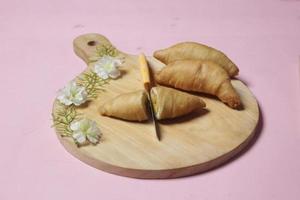 Chocolate bananas from raw materials covered with rolls of pastry dough sheets. Molen bananas with pastries are usually served with a cup of hot coffee or tea. Focus blur photo