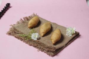 Chocolate bananas from raw materials covered with rolls of pastry dough sheets. Molen bananas with pastries are usually served with a cup of hot coffee or tea. Focus blur photo