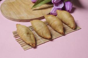 Chocolate bananas from raw materials covered with rolls of pastry dough sheets. Molen bananas with pastries are usually served with a cup of hot coffee or tea. Focus blur photo