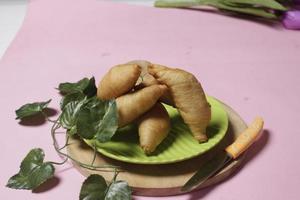 Chocolate bananas from raw materials covered with rolls of pastry dough sheets. Molen bananas with pastries are usually served with a cup of hot coffee or tea. Focus blur photo