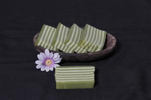 Original and pandan flavored layer cake. Layer cake is ready to accompany your morning with a glass of tea. Indonesian cake. We often see it as a side dish during Eid. Sweet and soft cake. Focus blur. photo
