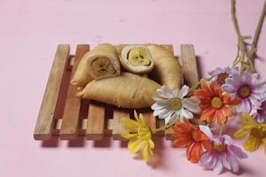 Chocolate bananas from raw materials covered with rolls of pastry dough sheets. Molen bananas with pastries are usually served with a cup of hot coffee or tea. Focus blur photo