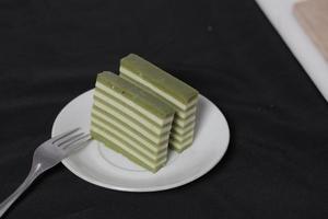 Original and pandan flavored layer cake. Layer cake is ready to accompany your morning with a glass of tea. Indonesian cake. We often see it as a side dish during Eid. Sweet and soft cake. Focus blur. photo