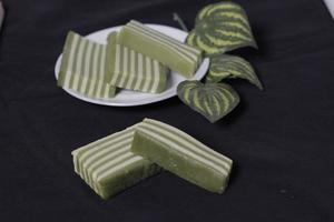 Original and pandan flavored layer cake. Layer cake is ready to accompany your morning with a glass of tea. Indonesian cake. We often see it as a side dish during Eid. Sweet and soft cake. Focus blur. photo