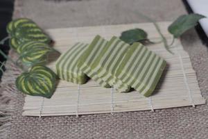 Original and pandan flavored layer cake. Layer cake is ready to accompany your morning with a glass of tea. Indonesian cake. We often see it as a side dish during Eid. Sweet and soft cake. Focus blur. photo