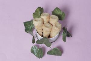 In Indonesia, this cake is known as cumcum cake. A cake shaped like a trumpet, or an ice cream cone. The perfect combination of a dry cake studded with sugar, plus a delicious cream vanilla filling. photo