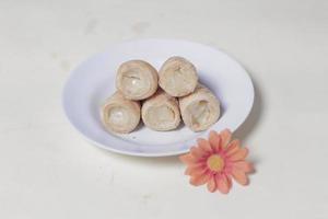 In Indonesia, this cake is known as cumcum cake. A cake shaped like a trumpet, or an ice cream cone. The perfect combination of a dry cake studded with sugar, plus a delicious cream vanilla filling. photo